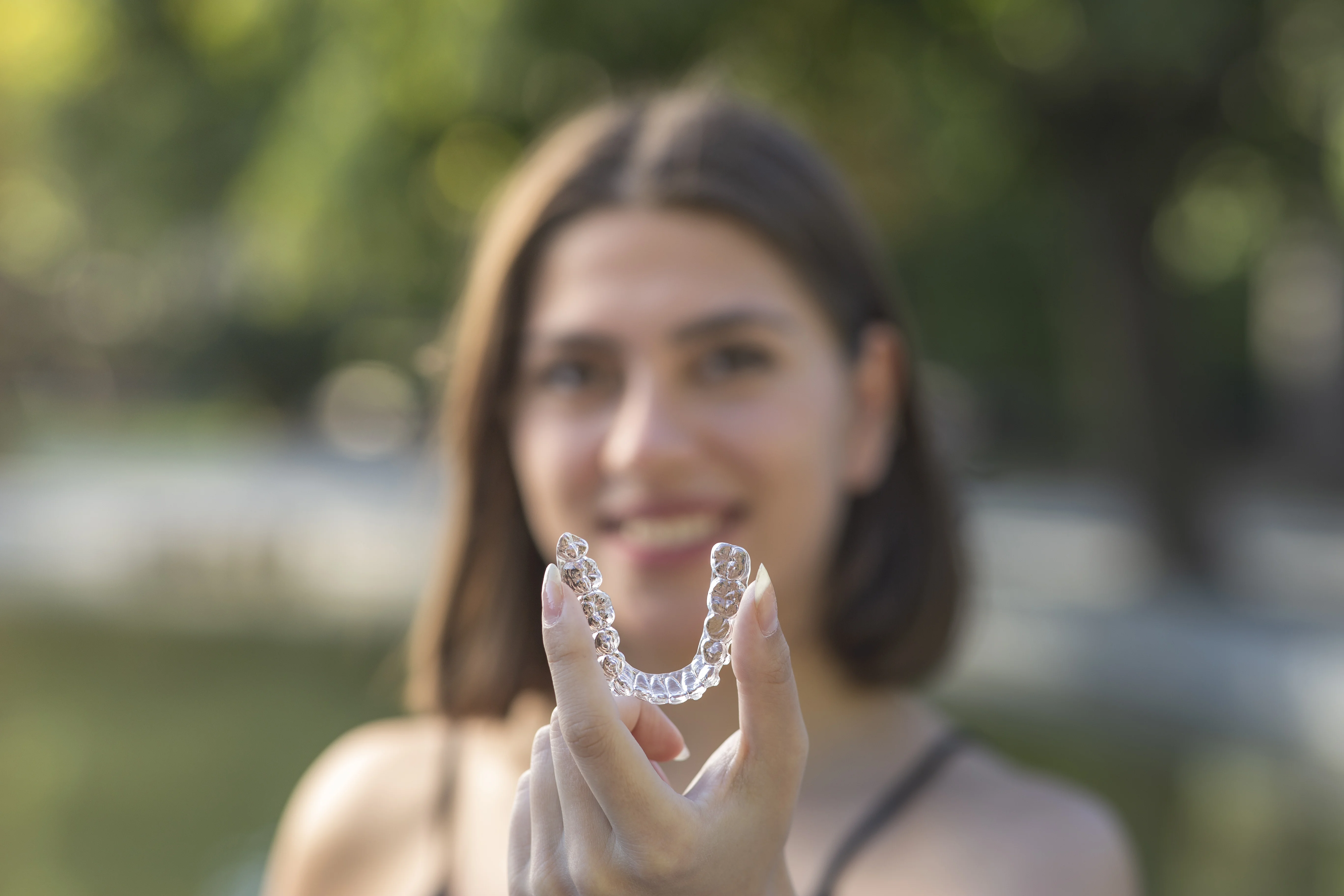 Patient holding Invisalign aligner